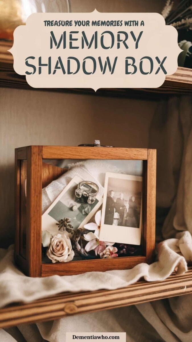 A cozy wooden shelf with a memory shadow box. The shadow box has a wooden frame and a glass front. Inside the box, there is a vintage ring, a small piece of fabric, pressed flowers, and old photographs. The background is a soft, neutral fabric. The lighting is warm and inviting. The text overlay says "Treasure your memories with a memory shadow box"
